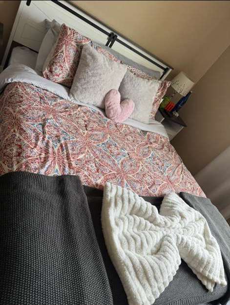 Neatly made bed with decorative pillows